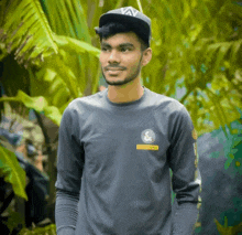 a man wearing a hat and a long sleeve shirt that says army on it