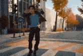 a man in a leather jacket is dancing in front of a bicycle sign