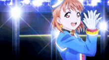 a girl in a blue uniform is waving her hands in front of a crowd .