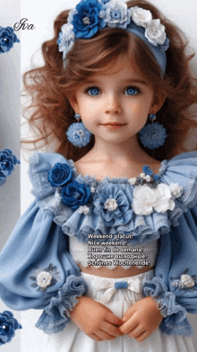 a little girl wearing a blue and white dress with flowers on her head