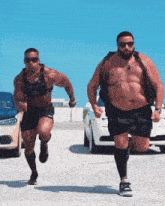 two men are running in a parking lot and one has a backpack on his back