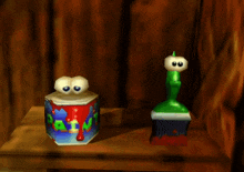 a box of paint sits next to a green brush on a table