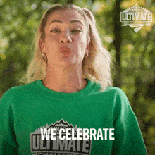 a woman wearing a green shirt that says we celebrate ultimate