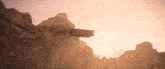 a space ship is flying over a mountain range