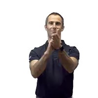 a man wearing a black polo shirt and a watch is clapping his hands