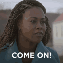 a woman with dreadlocks is looking at the camera and says come on