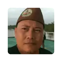 a man wearing a hat is making a funny face .