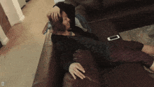 a person laying on a couch with the letter d on the bottom right corner