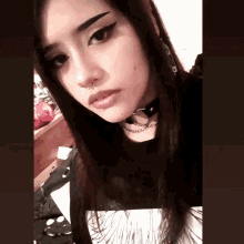 a woman wearing a choker and a nose ring