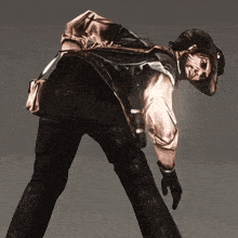 a man in a cowboy hat is bending over and looking down