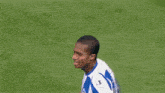 a soccer player wearing a blue and white jersey with the number 5 on the back