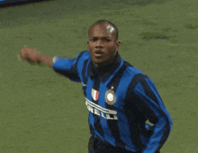 a soccer player wearing a blue and black striped shirt with the word irelli on it