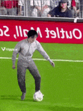 a man is kicking a soccer ball on a field with a sign that says viggle.ai