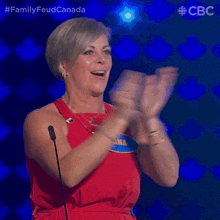 a woman in a red dress with a name tag that says ana is clapping