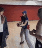 a group of women are standing on a wooden floor .