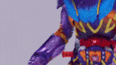 a close up of a purple robot with a red belt on a white background .