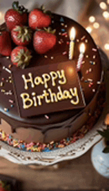 a chocolate birthday cake with strawberries and candles on top .