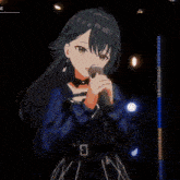 a girl with long black hair is singing into a microphone on a stage
