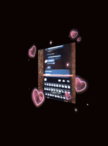 a blurry picture of a cellphone with hearts around it