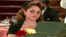 a woman sitting at a table reading a menu in a restaurant
