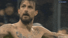 a shirtless man with a tattoo on his chest is being broadcast on cbs sports