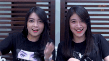 two girls wearing black shirts that say since