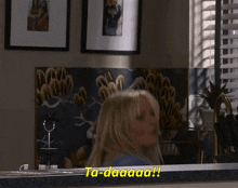 a woman says ta-daaaaa in a kitchen
