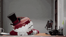 a cartoon tooth wearing a top hat is on a desk next to a microphone