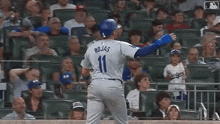a baseball player named rojas is standing on the field in front of a crowd .