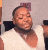 a man with a beard is making a funny face in a living room .