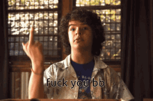 a boy with curly hair giving the middle finger and the words fuck you bb below him