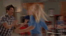 a group of people are dancing together on a dance floor .