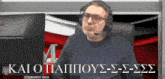 a man wearing headphones and glasses is sitting in front of a computer screen with kai o pappou written on the bottom right