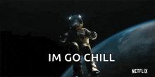 an astronaut is floating in space with the words im go chill behind him .