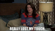 a woman is sitting on a bed with the words `` really lost my touch '' .