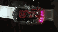 a close up of a toy with a red light on it