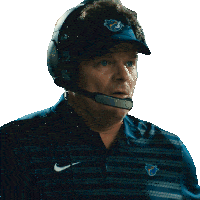 a man wearing a nike shirt and a hat with the letter f on it