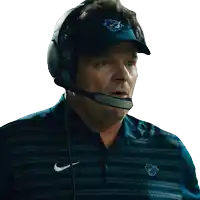 a man wearing a nike shirt and a hat with the letter f on it
