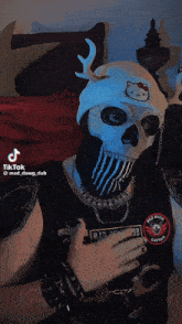 a person wearing a mask and a shirt that says mad dawg dub on the back