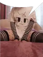 a person wearing a white shirt with a cat face on it