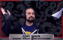 a man wearing headphones is standing in front of a sign that says kent rogue eugenio vargas @dmjazzyhands