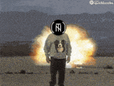 a man wearing a sweater with a dog on it stands in front of a large explosion
