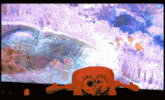 a spongebob squarepants toy is sitting in front of a coral reef