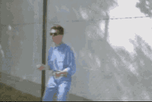 a pixelated image of a man in a blue shirt