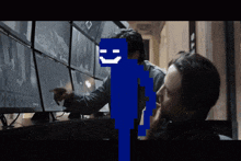 a pixelated image of a man pointing at a screen with a smiley face