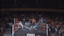 a wrestler without a shirt is waving his hand in the air