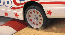 a red white and blue car with stars on the side and the number 50 on the side