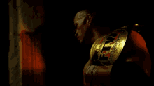 a man is holding a wrestling belt that says fm