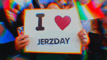 a person is holding a sign that says i heart jertzday