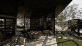 a patio area with a table and chairs under a covered area
